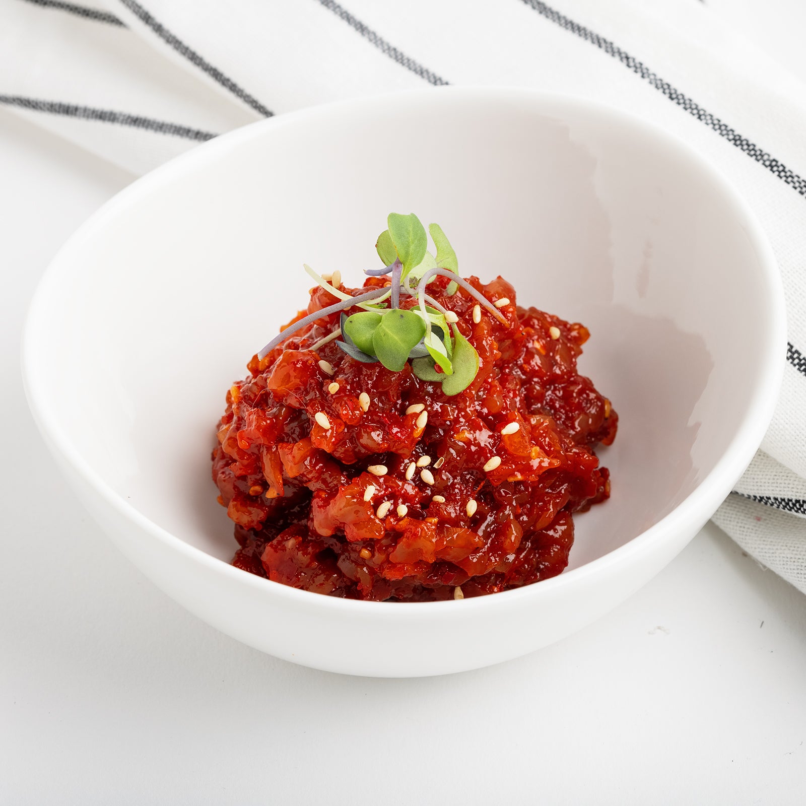 Ojingeo tangtangi (Korean spicy chopped squid, fermented) served and plated | Banchan365