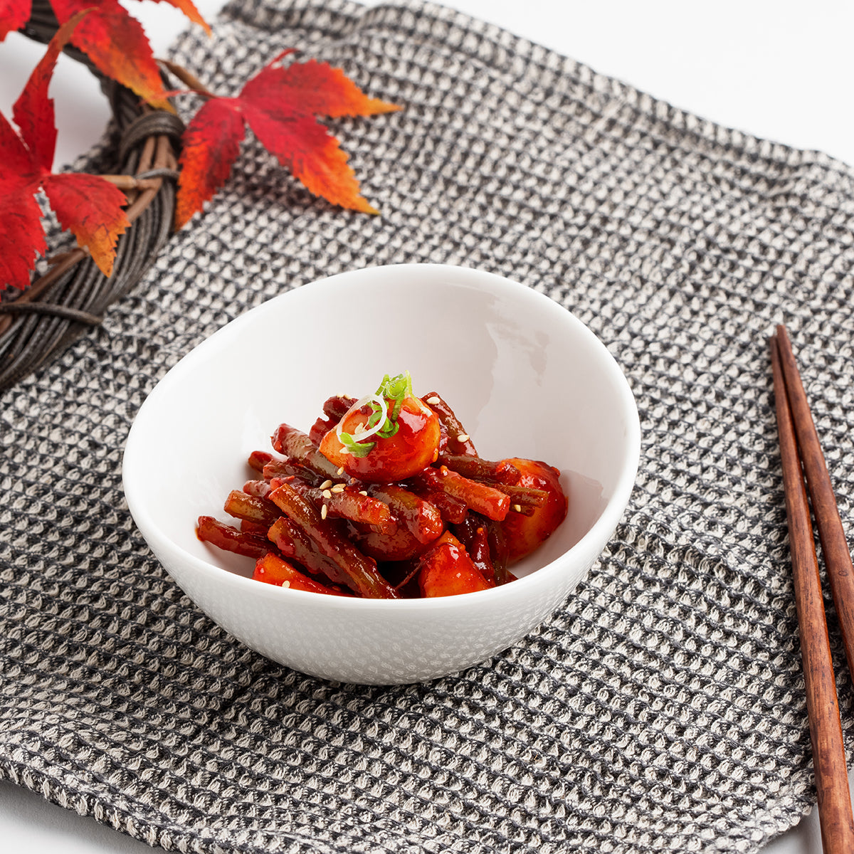 Close-up view of Maneul maneuljjong-muchim (Korean seasoned garlic and garlic scapes) – small family size | Banchan365