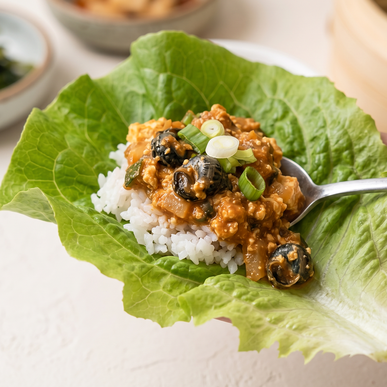 Close-up of Korean freshwater snail gangdoenjang ssamjang | Banchan365