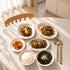 Korean birthday meal set with beef seaweed soup, bulgogi, japchae, tteokgalbi patties, kimchi and rice.