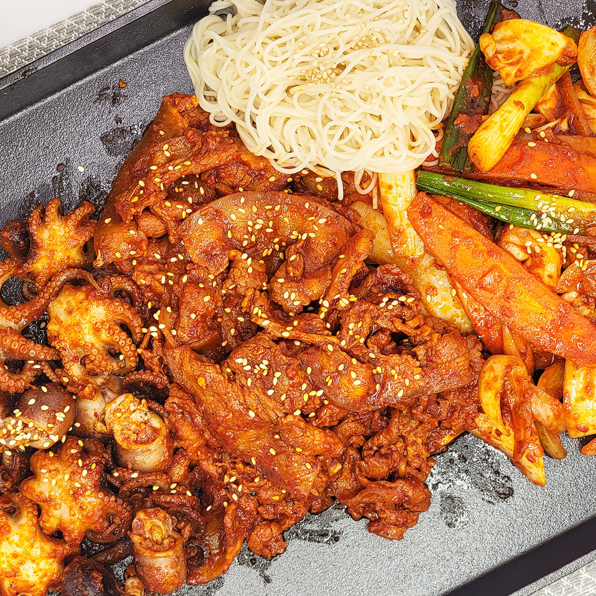 Close-up view of Jjukkumi samgyeopsal (Korean spicy baby octopus and pork belly) – 1.5 lb | Banchan365